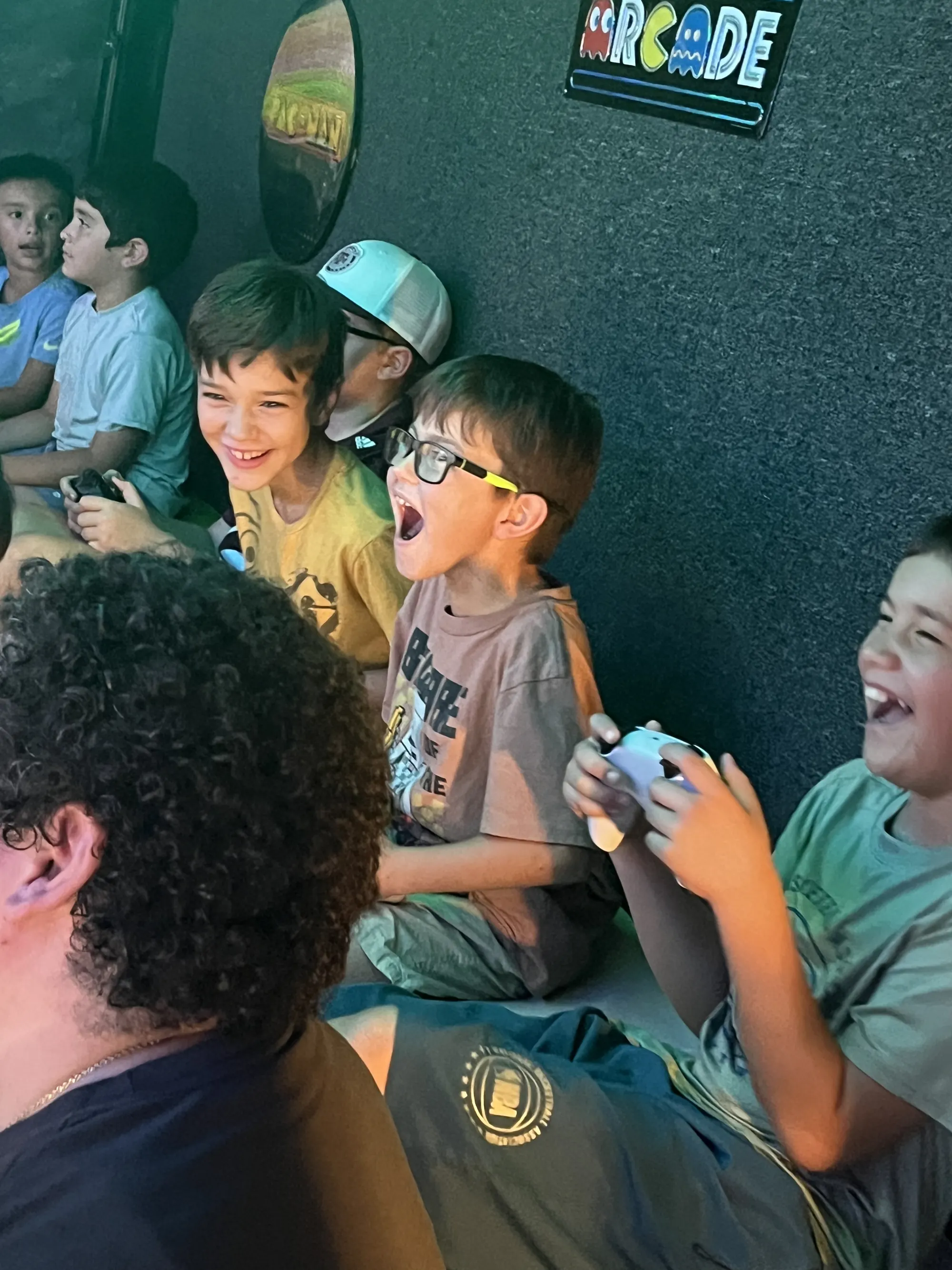 Friends laughing and cheering with controllers in hand