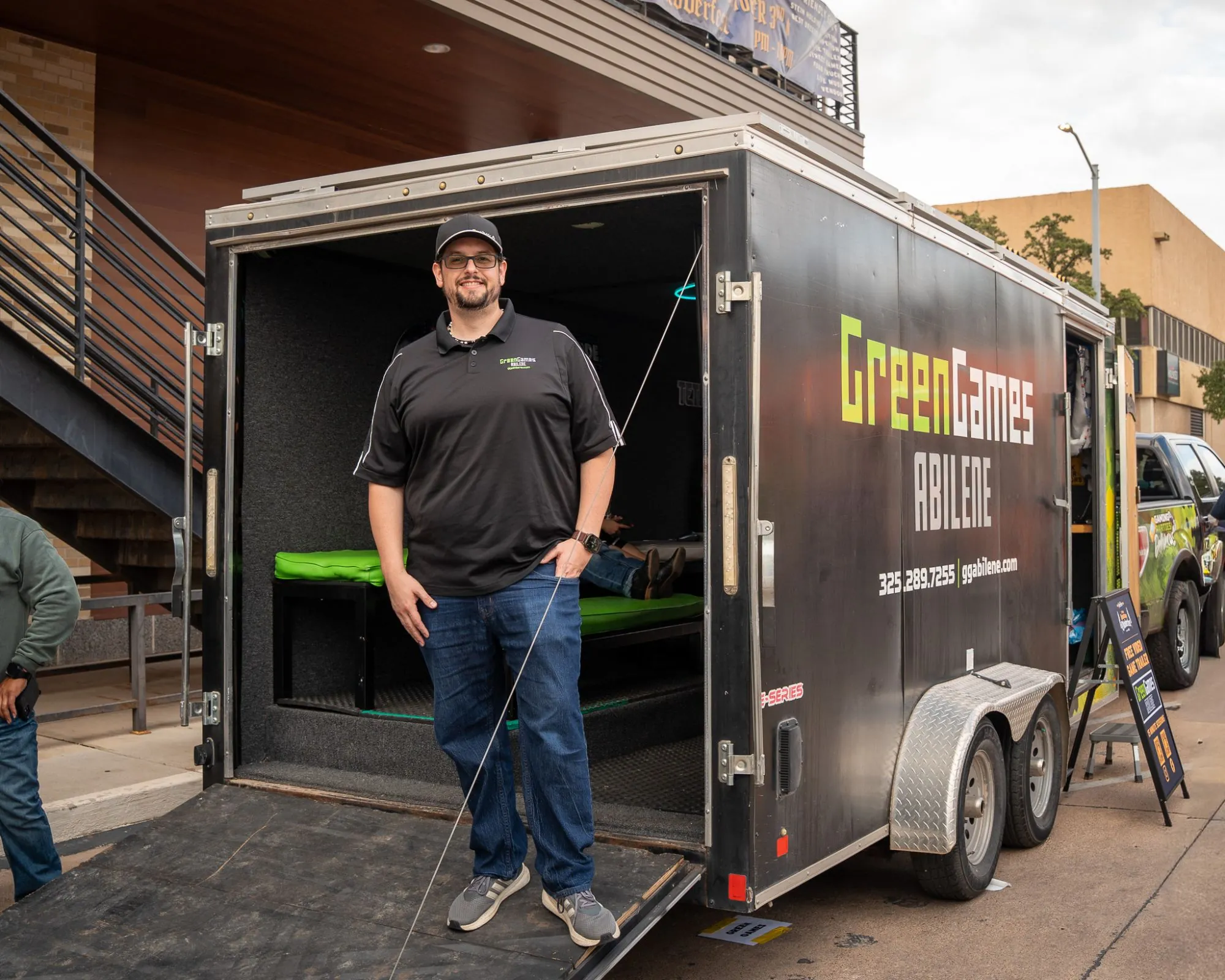 The owner of Green Games Abilene standing at the back of the gaming trailer