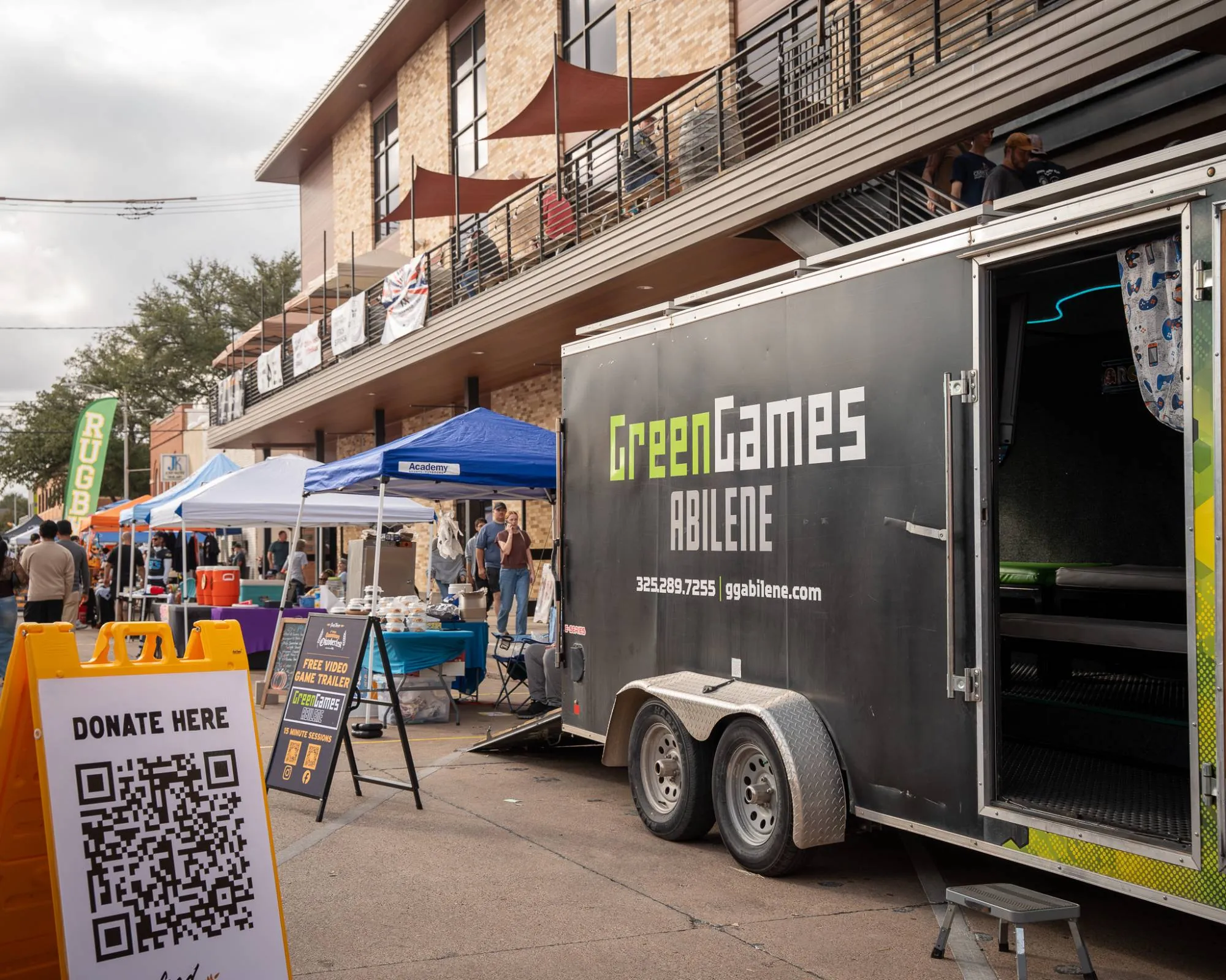 The Green Games trailer set up at a busy downtown community event